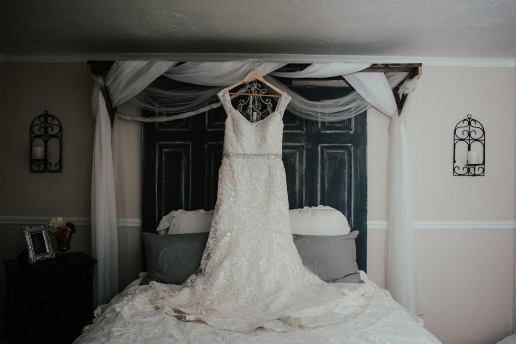The bride's gorgeous dress hanging in the master bedroom at Bridle Oaks.