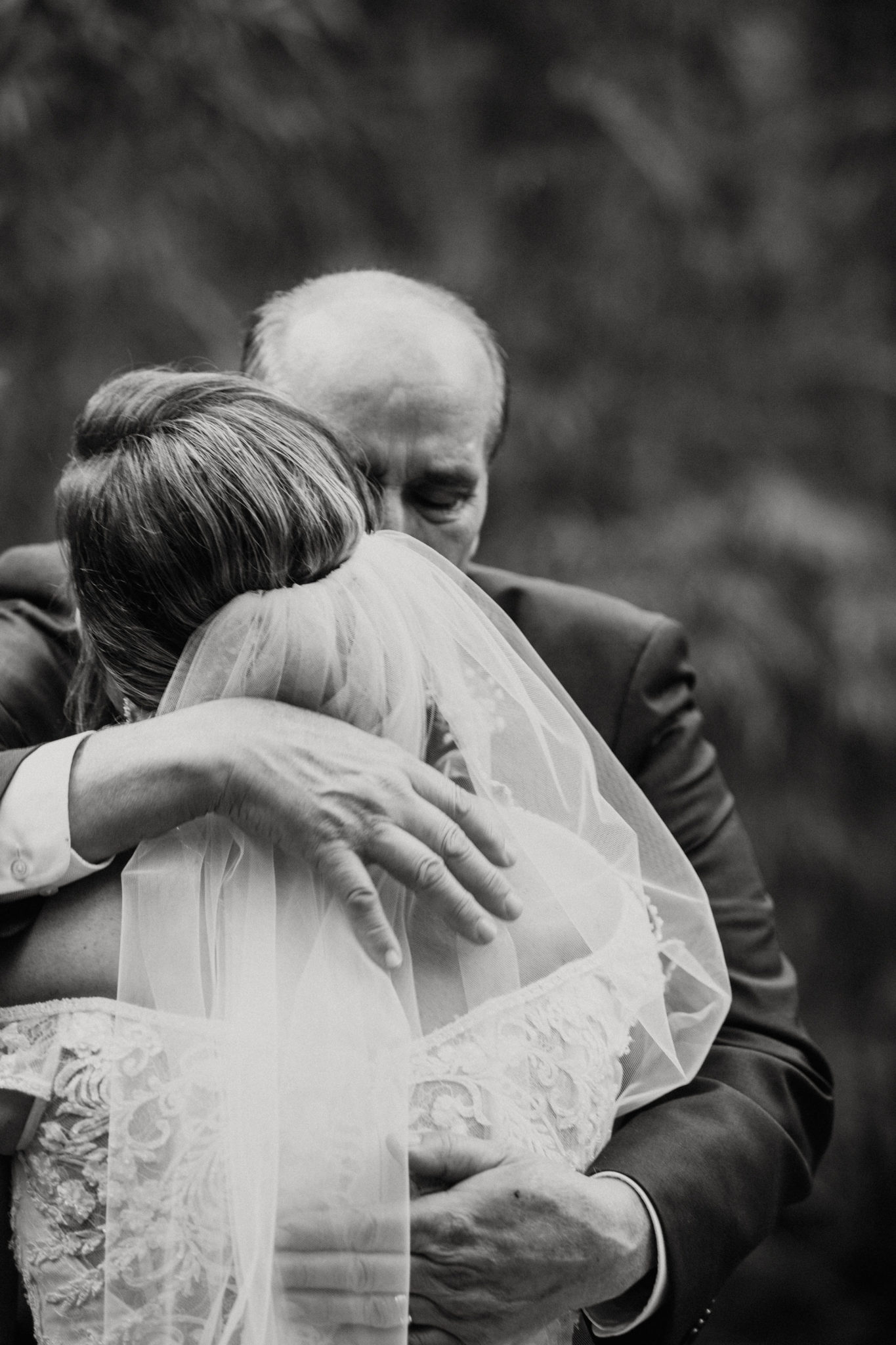 Father of the bride hugging his daughter.