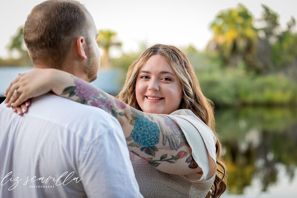 Amber smiling with her arms around Nathan during their Ormond Beach engagement session
