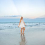 Ormond Beach senior photos of Ryann reflected in wet sand beneath a pastel sky